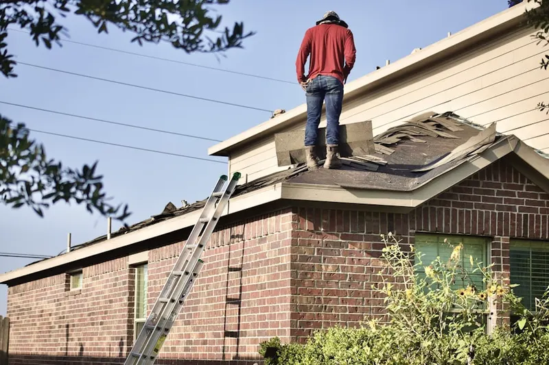 Professional roofer working on a residential roof in Kastle Estates
